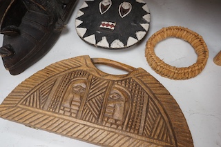 Three African tribal masks and a carved folding tray, largest 92cm. Condition - fair to good